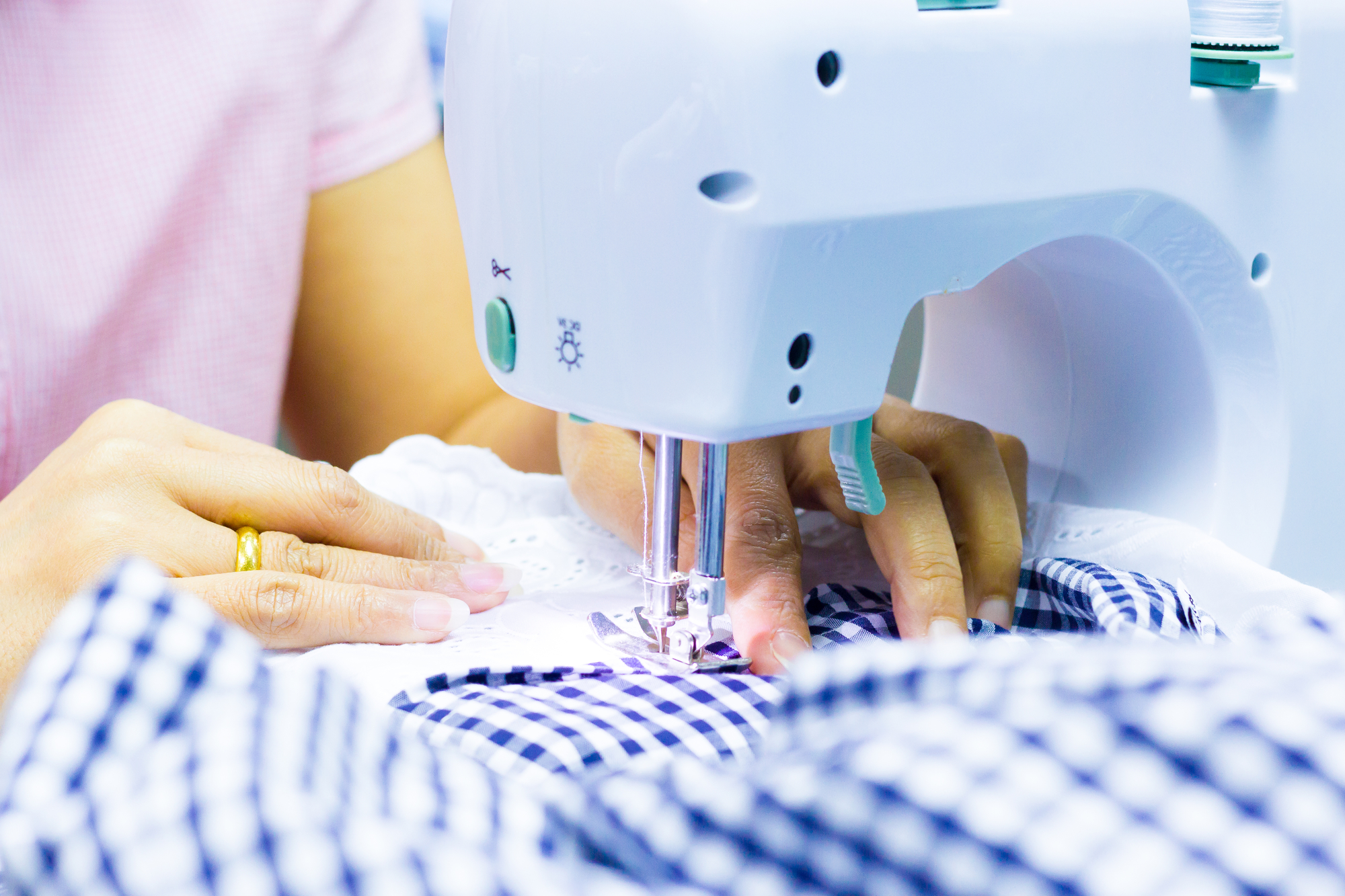 Best Portable Sewing Machine – Buyer’s Guide and Review woman working on a portable sewing machine