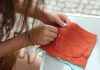 Basic Hand Sewing Tips That Everyone Should Know girl sewing by hand a piece of fabric